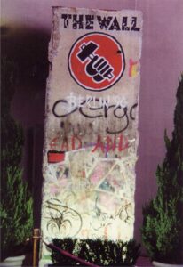 full shot of berlin wall segment, outdoors, with vivid paint